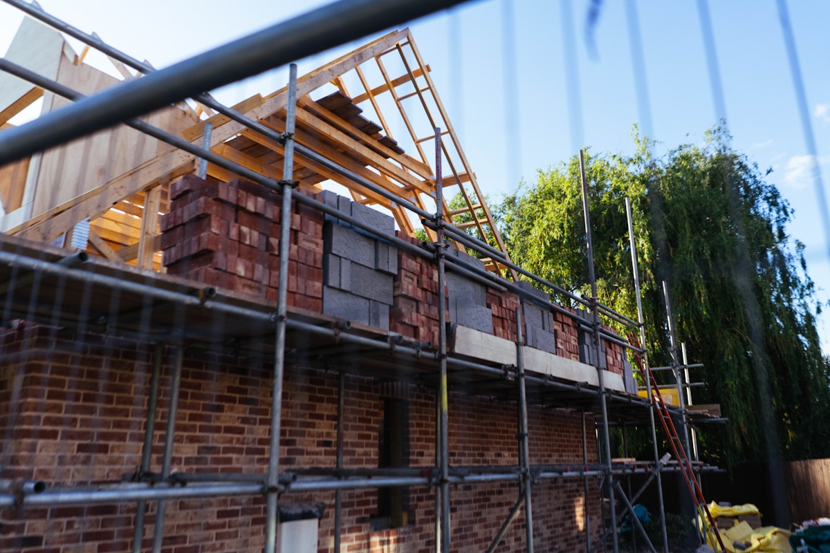 House under construction with bricks and scaffolding